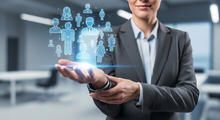 Business professional displaying a holographic interface with icons representing human resources and team members.