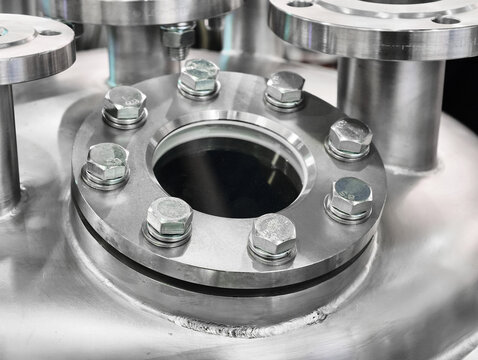 Close-up view of a metal industrial component showcasing precision engineering and secure fastening in a factory setting