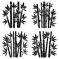 Obraz premium Four groupings of black bamboo stalks and leaves in a symmetrical arrangement on white background
