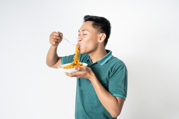 Asian man eats noodles with enthusiasm, capturing a moment of joy and enjoyment during a meal.