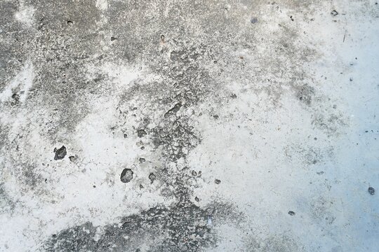 Concrete cement background that is creaking due to age. Texture of weathered white painted concrete surface. old dirty wall texture
