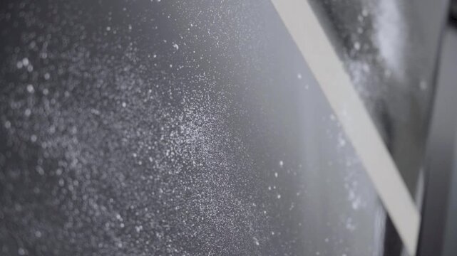 Use an air gun to blow off the dust on the car paint