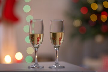 two glasses of champagne and christmas tree