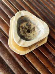 cigarette butt ashtray on bamboo table