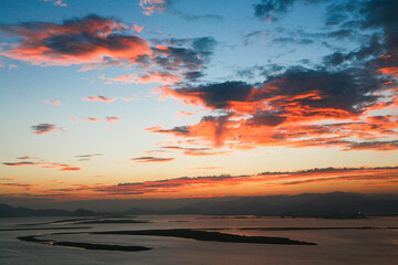 A beautiful beach scene with a red sunset.