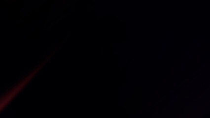 Dramatic red light streak illuminating dark night sky evoking mystery and excitement