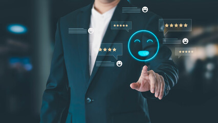 A businessman in a suit touches a virtual interface, selecting a smiling emoji and giving a five-star review. This represents excellent customer satisfaction and modern service feedback.