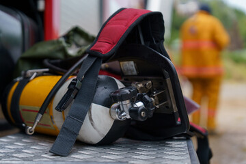 Focus on the tank and fire hose working together to put out the fire.