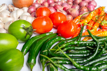 Various raw spices for cooking ingredients on white background; onion, garlic, chili, tomato