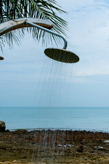 Tropical beach paradise outdoor shower with palm trees and sea views