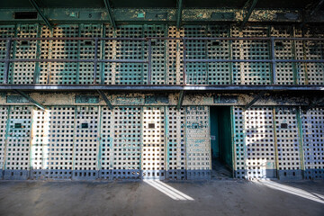 A prison cell block with bars on the windows