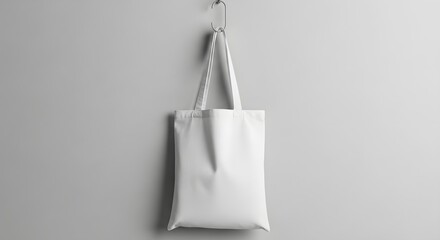 Eco-friendly white canvas shopping bag hanging on a wall, a blank template for custom design and logo presentation
