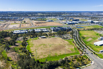 Drone aerial photograph of a large grass sports field in the fast growing suburb of Oran Park in the Macarthur Region of South Western Sydney in New South Wales, Australia. 