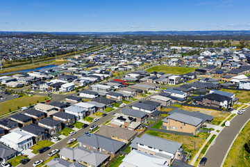 Fototapeta premium Drone aerial photograph of residential houses and neighbourhoods in the fast growing suburb of Oran Park in the Macarthur Region of South Western Sydney in New South Wales, Australia. 