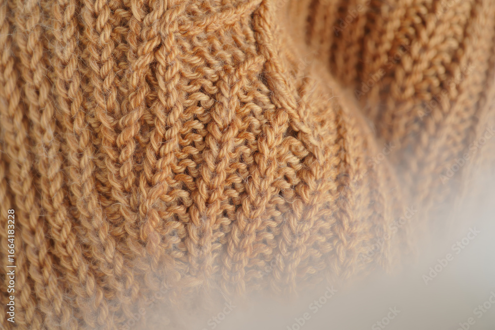 Poster close up of a textured beige knit fabric showing the intricate pattern and soft material surface det