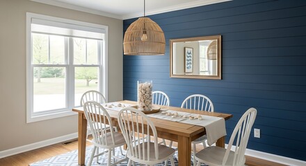 Modern farmhouse dining room with a dark blue accent wall and natural light.