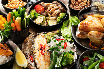 Table scene of various delicious foods. Healthy, family dinner.