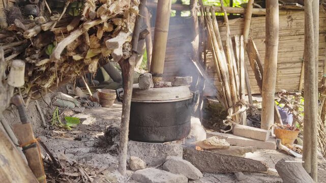 Traditional palm wine distillery in rural Flores, Indonesia, producing arak or sopi alcohol from fermented sap, rustic village distillation