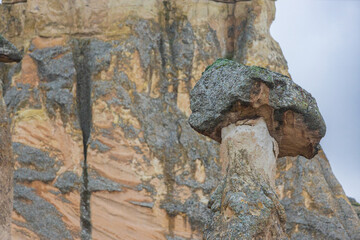 Close-up of butte on top of Tent rock in Goreme National Park and the Rock Sites of Cappadocia, Turkey. Stone pillar from basalt and tuff. Cliffs in Nevsehir Province in the Cappadocia, Central Anatol