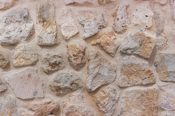 light stone wall texture background from natural tufa or sandstone rocks