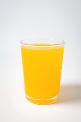 Orange juice in a glass on white background