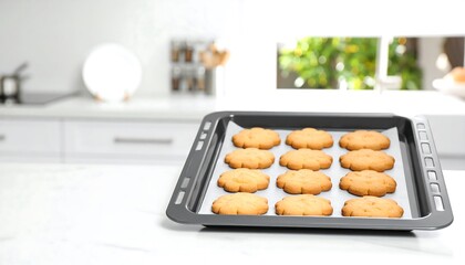 Freshly baked cookies arranged on a baking sheet, ready for enjoyment in a modern kitchen.