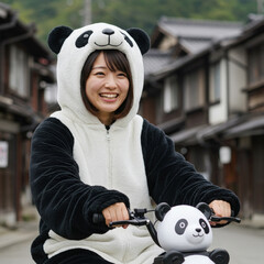 Cute Japanese young lady dressing in cute panda theme costume riding cute panda theme bicycle in Japanese old town.