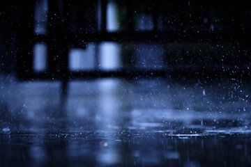 Obraz premium heavy raining make many small splash crown from water droplets drop down to the concrete floor in blue tone color scene