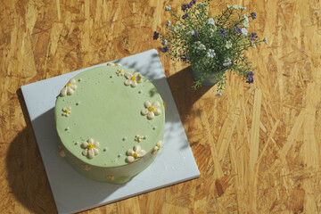 top view flat lay shot a green lime birthday cake on wooden table