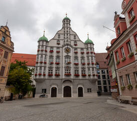 The historic Town Hall (Rathaus) of Memmingen, is a large, ornate building with a central tower and green domes