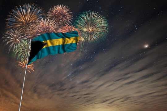 Waving National flag of Bahamas and holiday fireworks