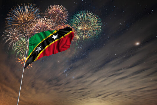 Waving National flag of Saint Kitts and Nevis and holiday fireworks