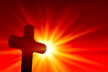 A Christian cross in the red sky with a flaming sun 