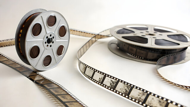 A vintage movie projector with a film reel and filmstrip