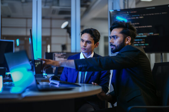 A diverse team of AI developers shares a successful moment in the office. A female programmer smiles as they review the positive results of a complex machine learning algorithm. - Powered by Adobe