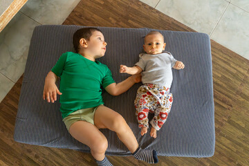 Anjali and Emerson cuddle on the mattress