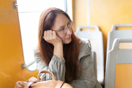 Pensive woman contemplating during commute on public transport