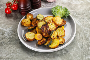 Roasted young zucchini in the plate