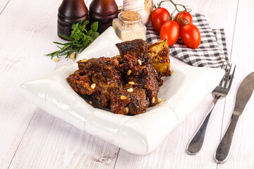 Prepared tasty beef ribs with sauce