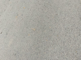 Rough Gray Concrete Surface with Embedded Pebbles and Discoloration Patterns