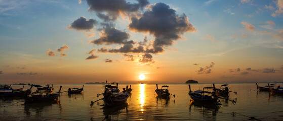 Silhouette panorama, beautiful landscape with sunrise at coast of Andaman sea in summer. Group of...