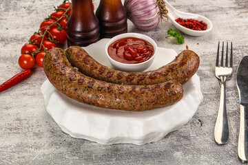 Grilled beef sausages with sauce