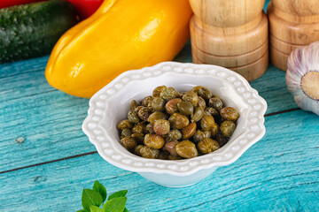 Pickled canned capers in the bowl