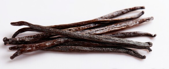 The vanilla beans arranged on white background for cooking and baking inspiration