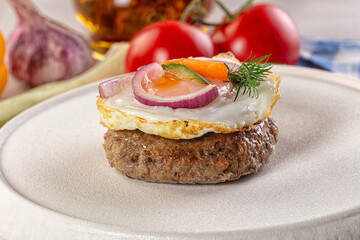 Beefsteak chop with roasted egg