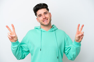 Young caucasian man isolated on white background showing victory sign with both hands