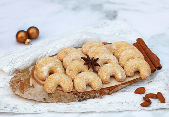 Christmas cookies: Baked vanilla crescents on a wooden board.