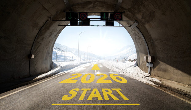 The words &lsquo;2026 START&rsquo; written on a road emerging from a tunnel between snow-covered mountains. An inspiring concept symbolising the start of the new year, hope, goals and looking ahead.