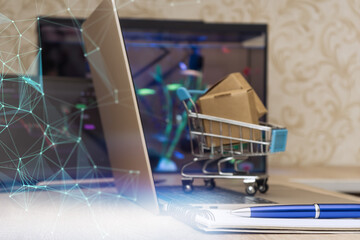 Mini shopping cart with parcels on laptop, network connections overlayed, symbolizing modern ecommerce, logistics and digital retail innovation.