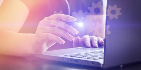 Woman configuring digital system on laptop